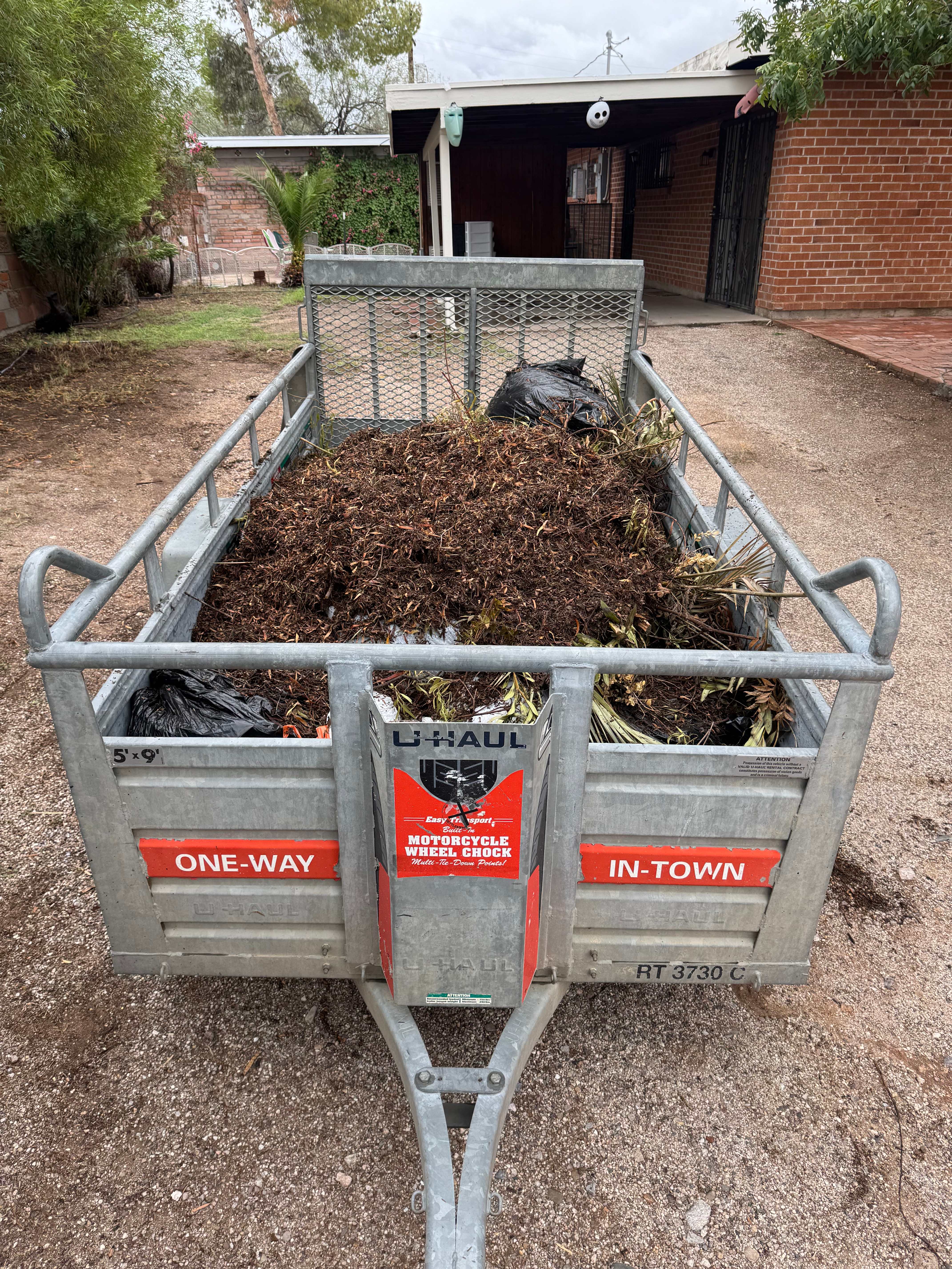 Yard waste removal - trailer full of mulch and debris