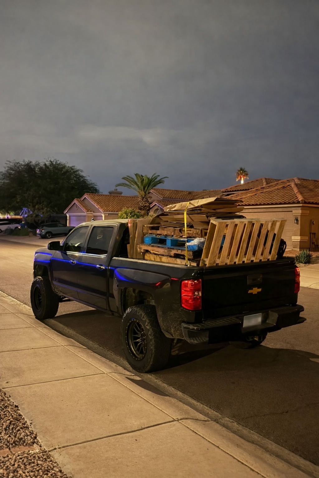 Phoenix junk removal truck loaded with pallets at night